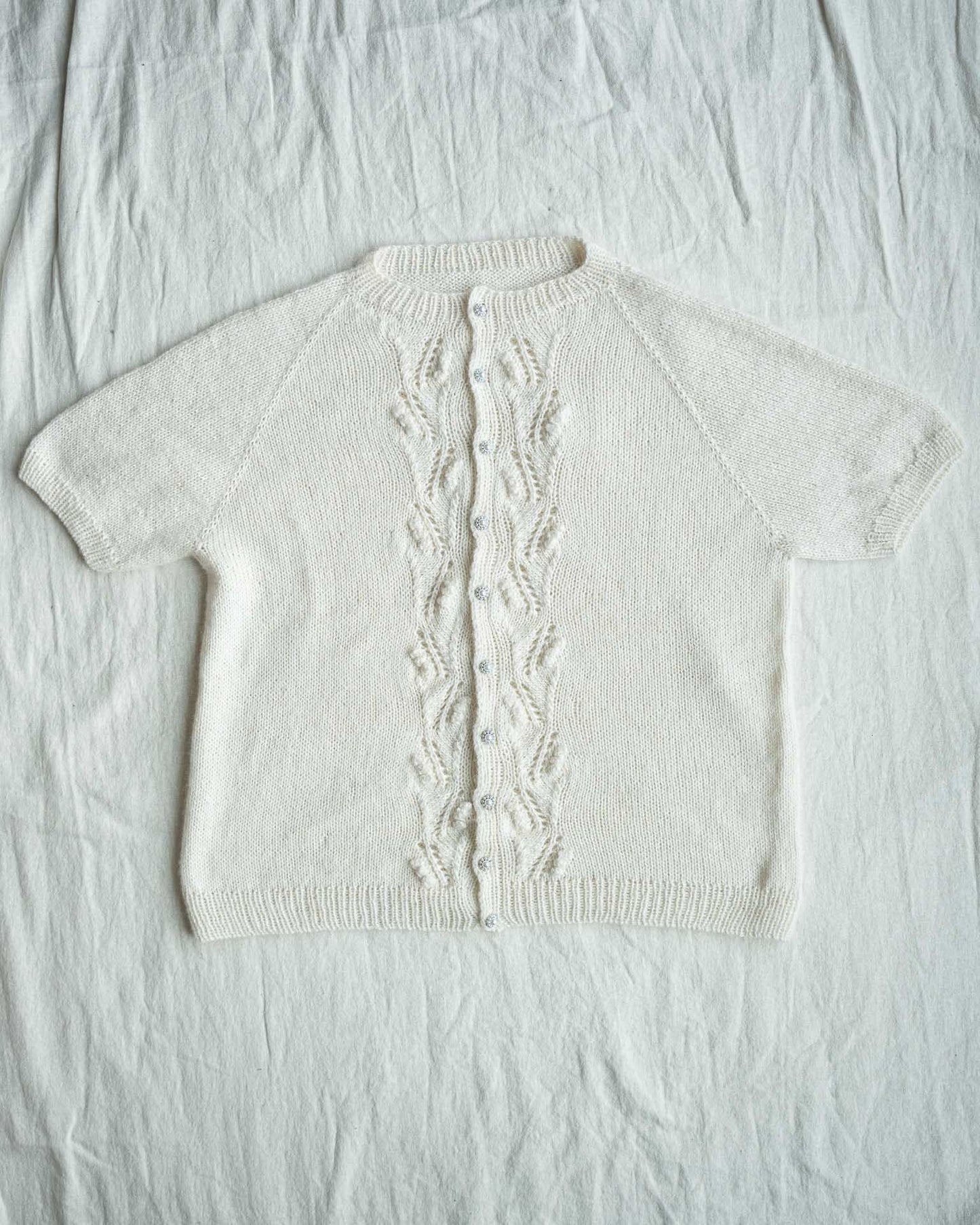 Helga Kortermet Cardigan er en lekker og stilren sommertopp med struktur på fremsiden. En vakker og pyntet cardigan som passer til uken og til fest.